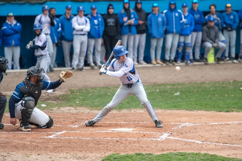 Baseball players compete during a home game.