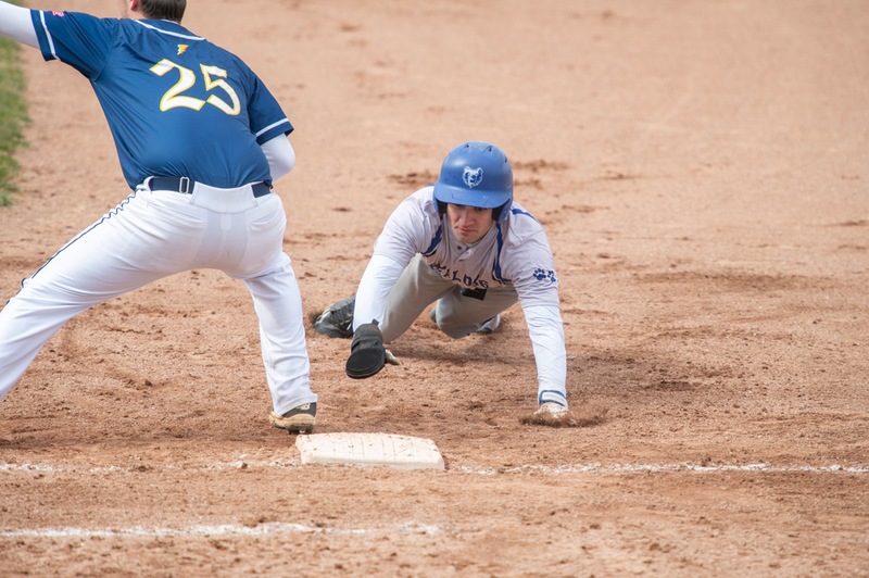Baseball players compete during a home game.