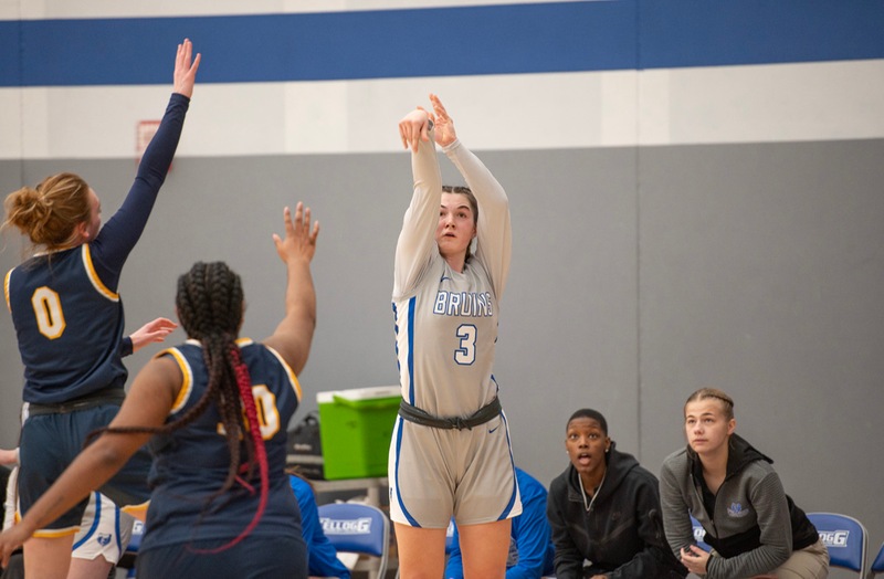 Women's basketball players compete during a home game.