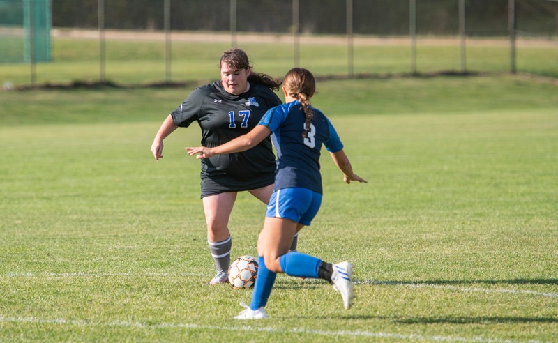 Women's soccer players compete during a home game.